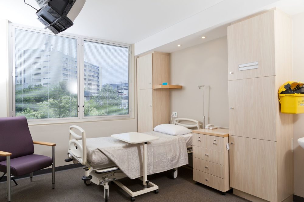 hospital ward with bed and medical equipment